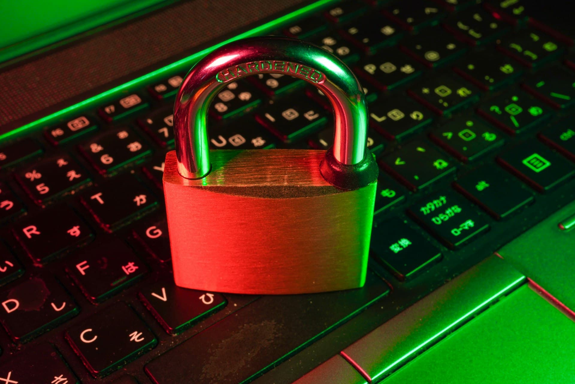 Red padlock resting on a black computer keyboard
