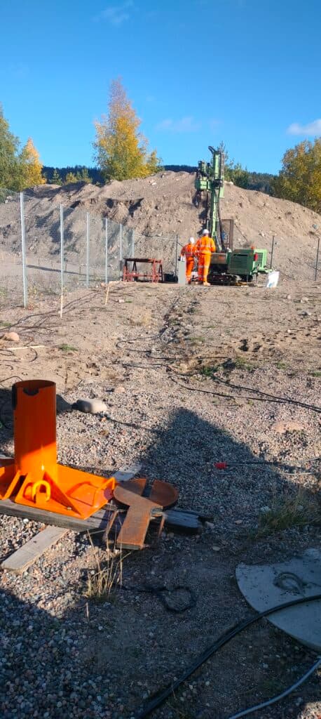Civil borehole drilling site showing access and surrounding ground