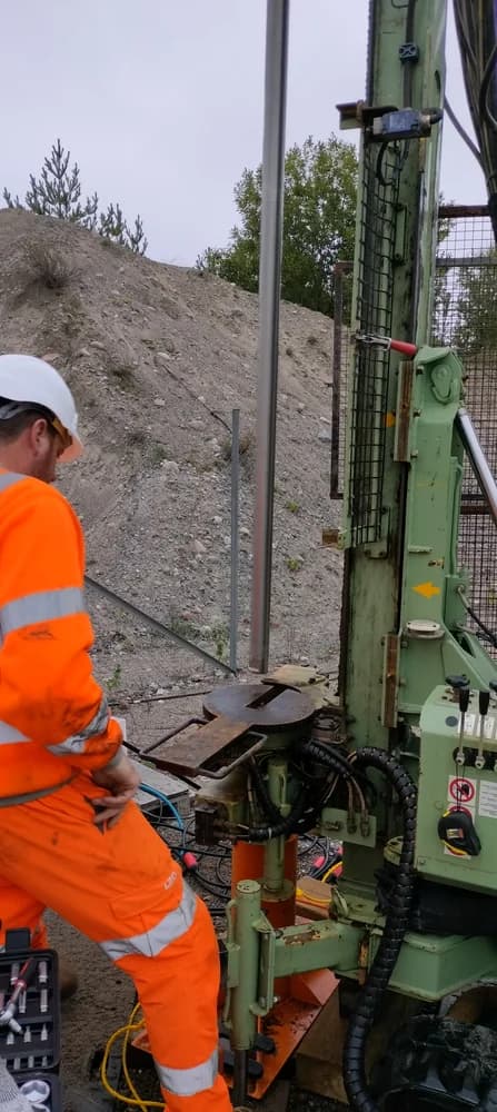Field crew working beside borehole drilling equipment