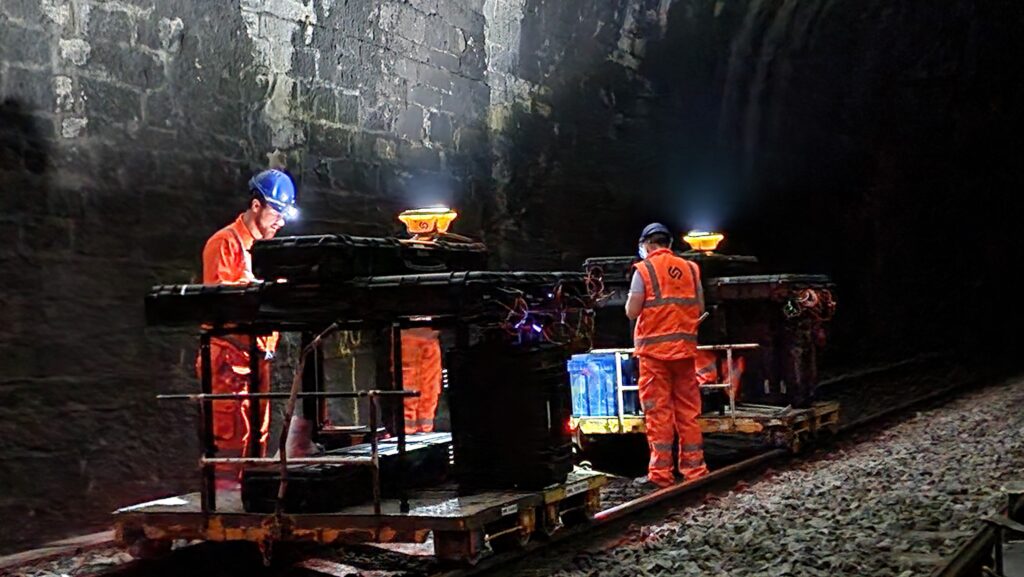 Geoptic survey staff working with muon detector systems inside a tunnel